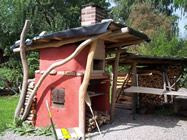 Holzbackofen mit Bausatz "Finum" und Flachdach sowie durchgängig gemauertem Kamin